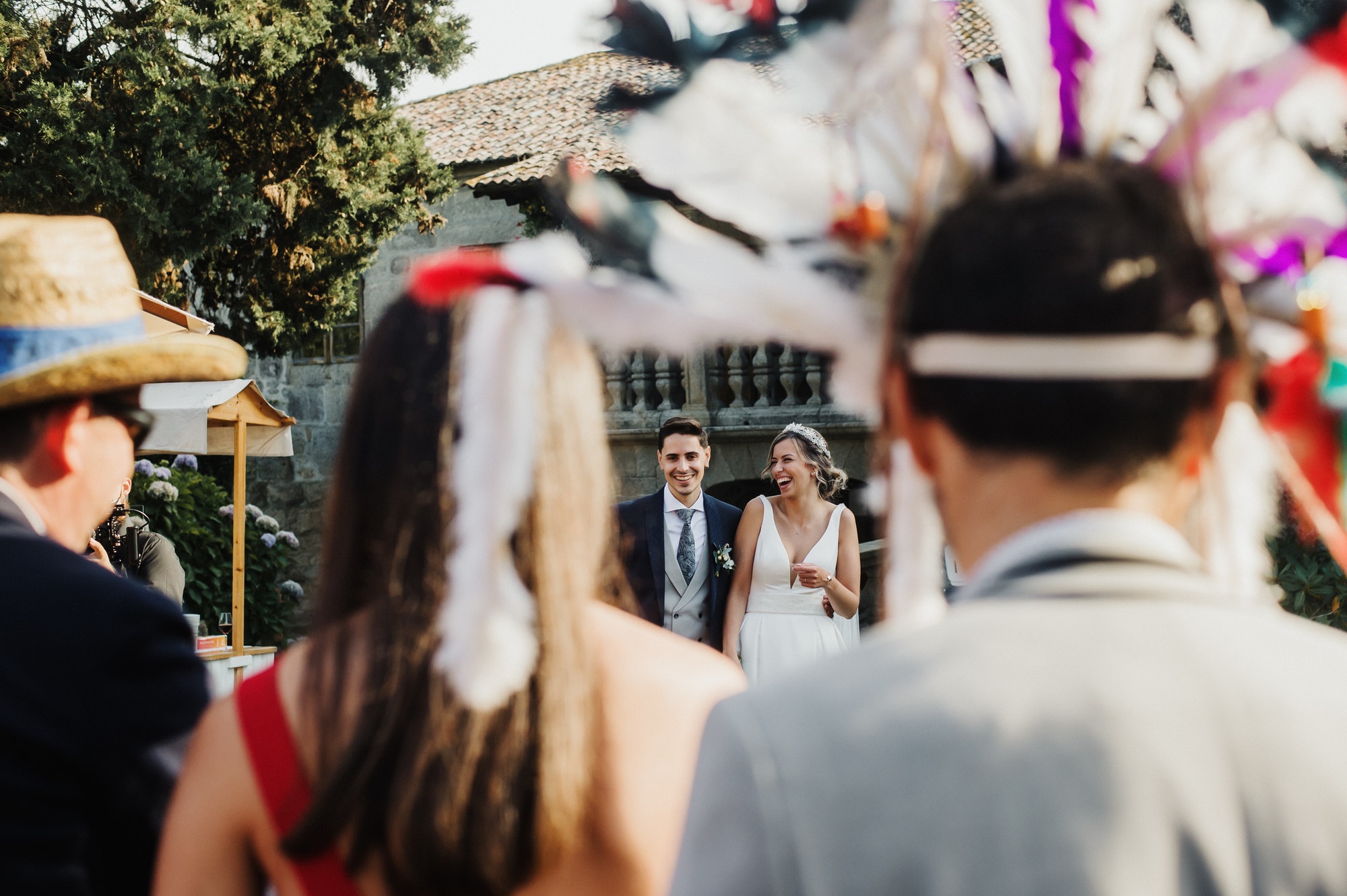 Couple laughing at their wedding with guests in disguise